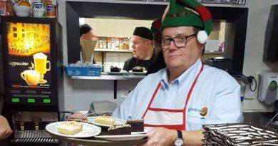 man in elf hat with tray of food