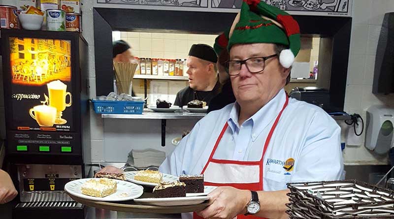 man in elf hat with tray of food