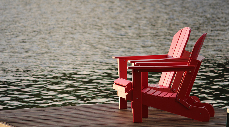 two red chairs on dock
