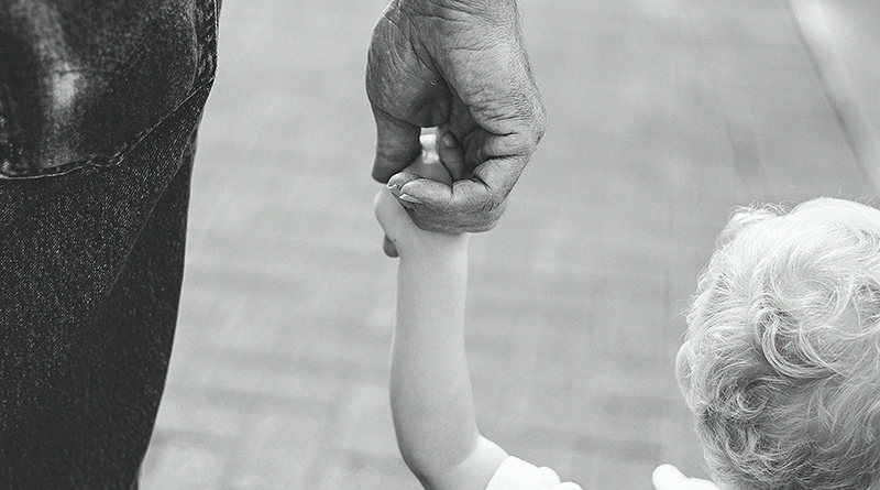 dad holding childs hand