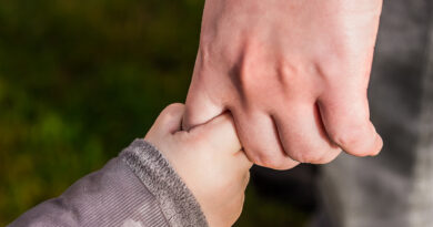 child holding parent hand