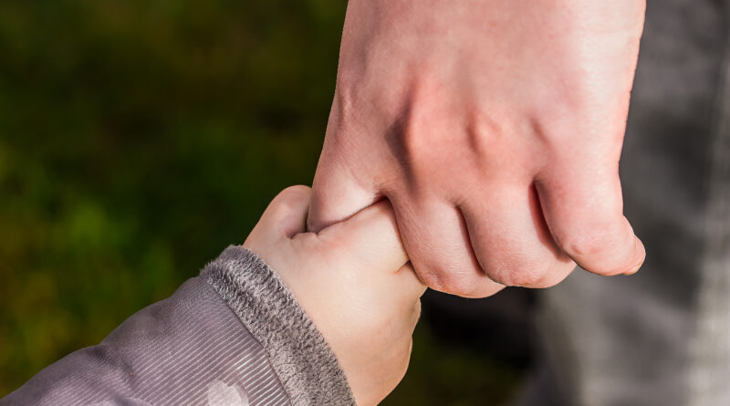 child holding parent hand