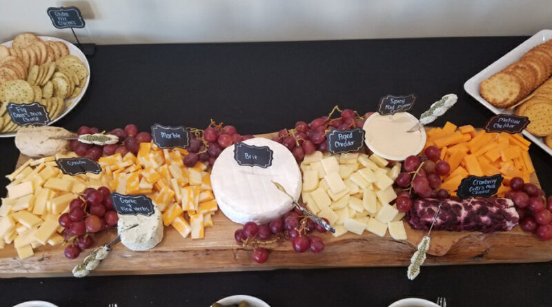 Cheese board with cheese and grapes