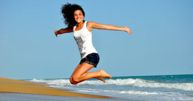 girl on beach jumping